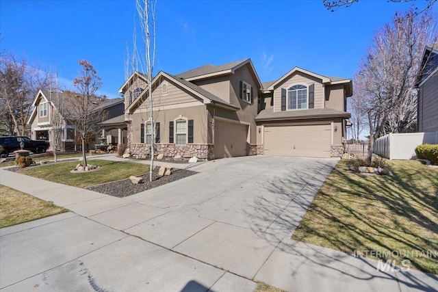 view of front of property with stucco siding, stone siding, fence, concrete driveway, and a garage