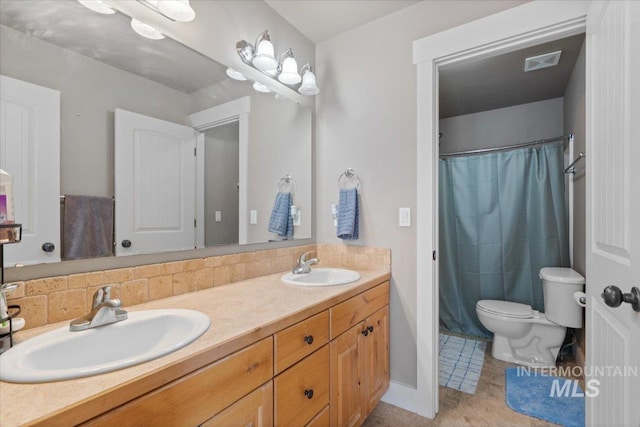 full bath with double vanity, toilet, visible vents, and a sink