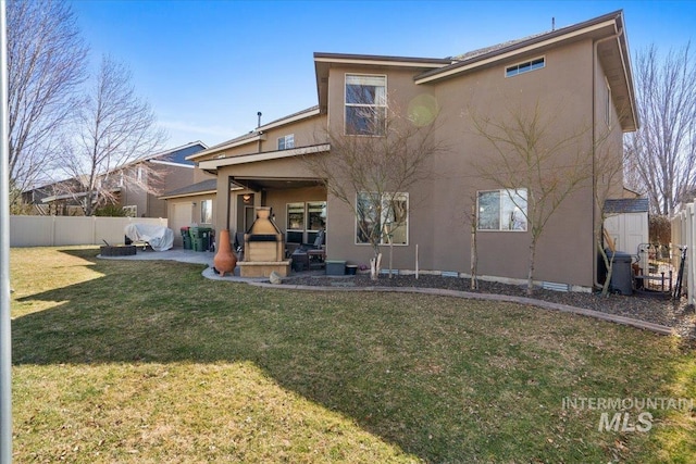 back of house with stucco siding, a fenced backyard, a yard, a patio area, and an attached garage