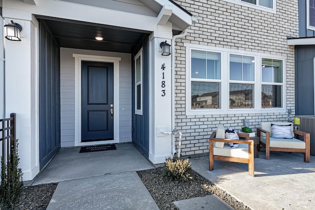 doorway to property featuring central AC unit