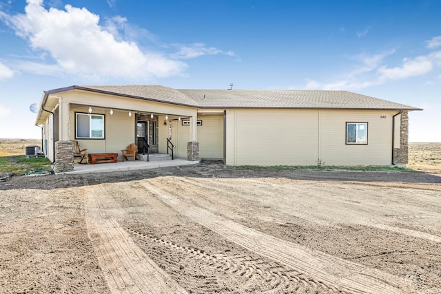 view of front of home with a garage and central AC unit