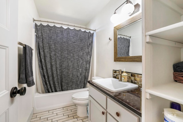 full bathroom with toilet, large vanity, tile floors, and shower / tub combo