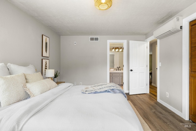 473 E Ranch Dr, Eagle, ID 83616 - bedroom with dark wood-type flooring, an AC wall unit, baseboards, and ensuite bathroom