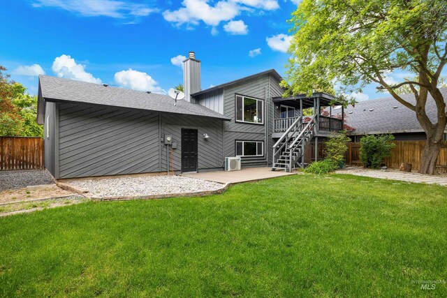 473 E Ranch Dr, Eagle, ID 83616 - rear view of house featuring a patio area, stairway, a chimney, a wooden deck, and roof with shingles
