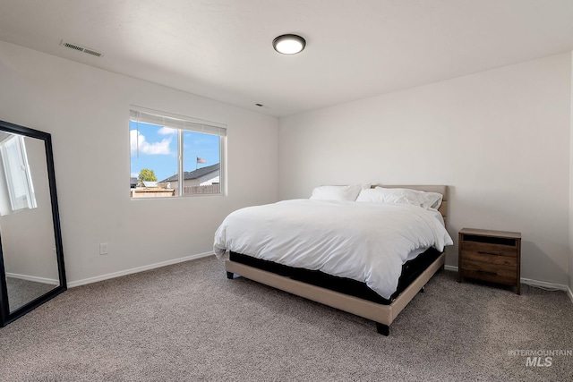 carpeted bedroom with visible vents and baseboards
