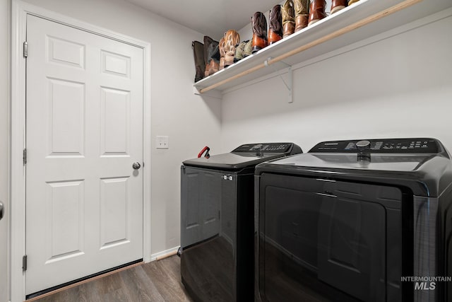 laundry area with washer and clothes dryer, dark wood-style floors, laundry area, and baseboards