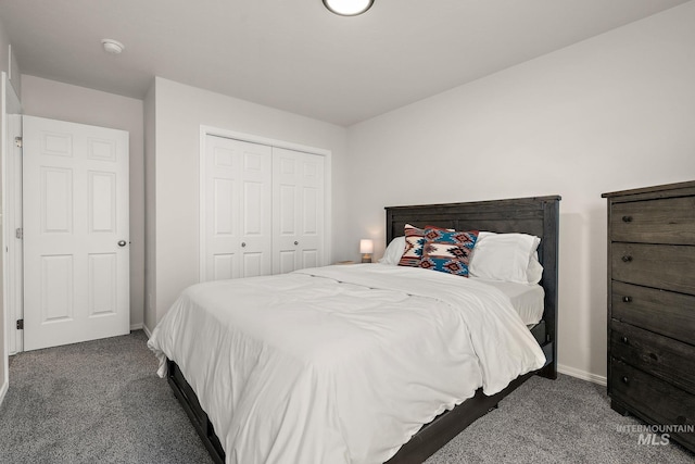 bedroom featuring a closet, carpet flooring, and baseboards