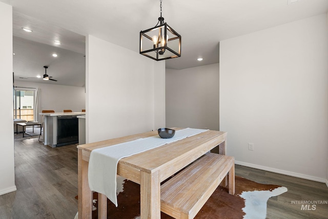 dining area with recessed lighting, ceiling fan with notable chandelier, baseboards, and dark wood-type flooring