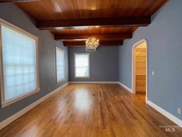 unfurnished room featuring light hardwood / wood-style floors, a chandelier, wooden ceiling, and beamed ceiling