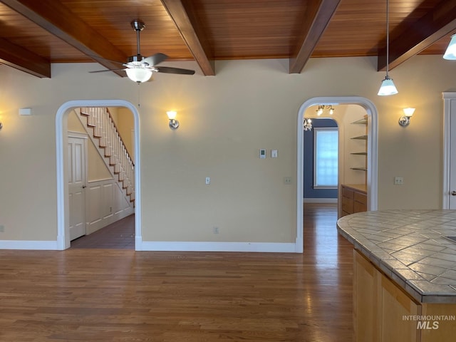 interior space with wooden ceiling, ceiling fan, and dark hardwood / wood-style floors