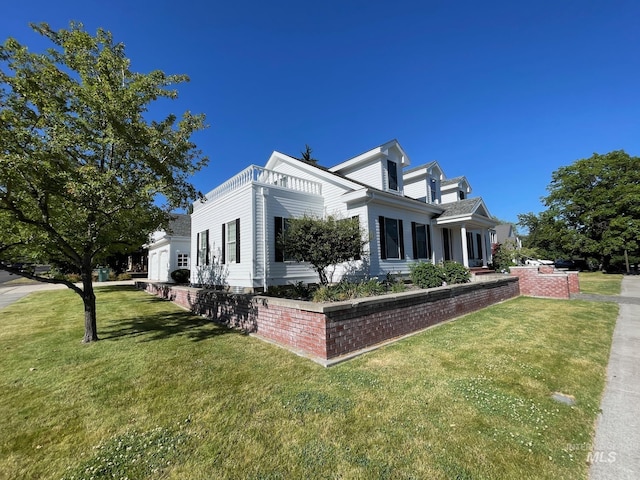 view of side of property with a lawn