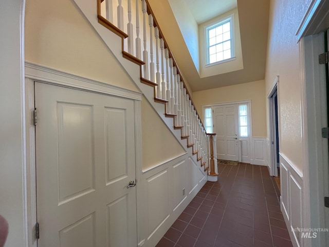 tiled entryway with a towering ceiling