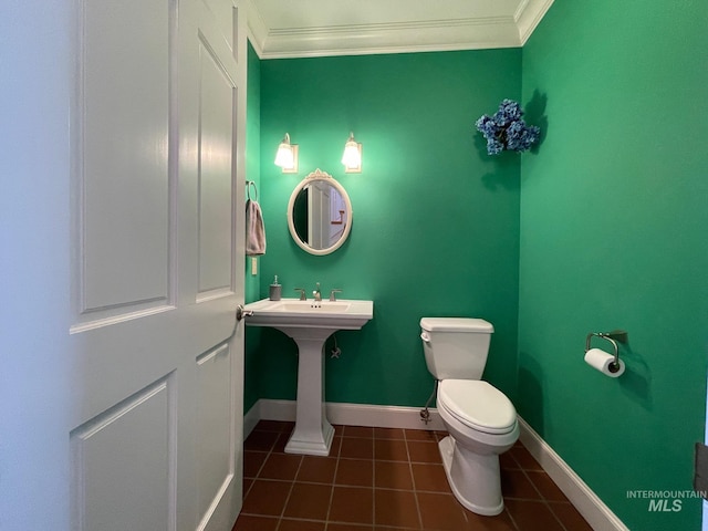 bathroom featuring toilet, tile patterned flooring, and crown molding