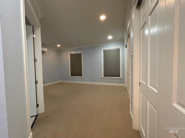 corridor with light colored carpet, ornamental molding, and a wall mounted air conditioner