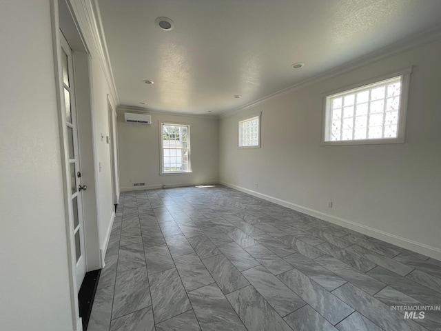 unfurnished room featuring a wall unit AC and crown molding