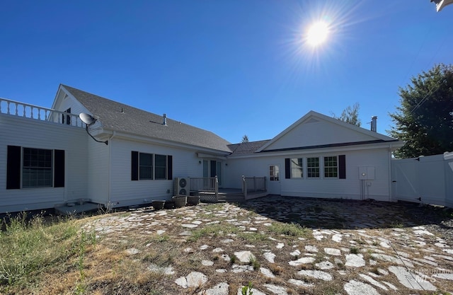 back of property with a wooden deck