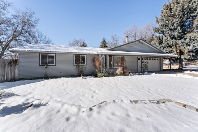 ranch-style house with a garage and fence