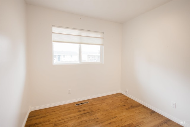 unfurnished room featuring wood finished floors and baseboards