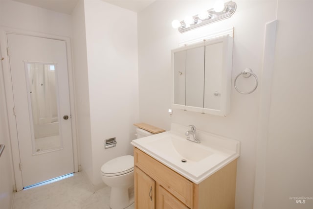 half bathroom featuring toilet, vanity, and baseboards