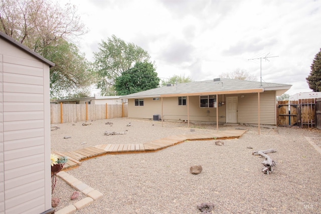 back of house with a fenced backyard, a wooden deck, and central AC unit