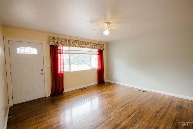 foyer featuring ceiling fan, wood finished floors, and baseboards