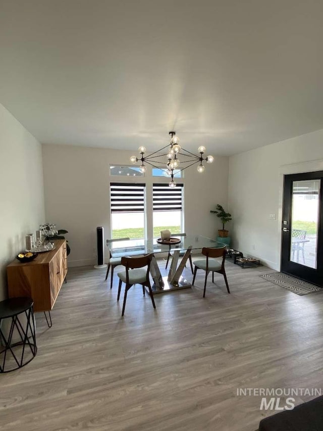 dining room featuring hardwood / wood-style floors and a notable chandelier