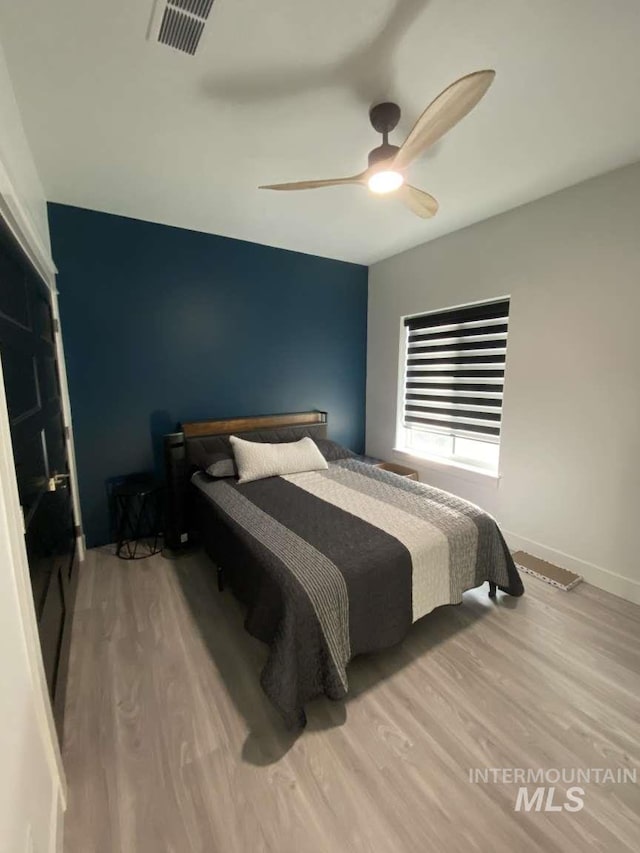 bedroom featuring hardwood / wood-style floors and ceiling fan