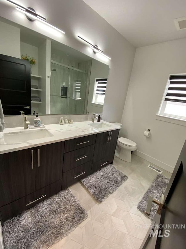 bathroom with vanity, toilet, and walk in shower