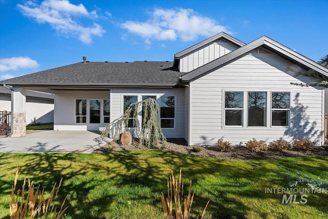 rear view of house with a yard and a patio