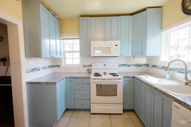 260 State St, Grand View, ID 83624 - kitchen featuring white appliances, a sink, decorative backsplash, and light tile patterned floors