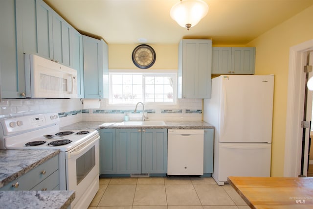 260 State St, Grand View, ID 83624 - kitchen with white appliances, a sink, tasteful backsplash, light tile patterned floors, and light stone countertops