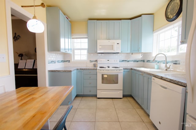 260 State St, Grand View, ID 83624 - kitchen featuring white appliances, blue cabinets, a sink, and tasteful backsplash