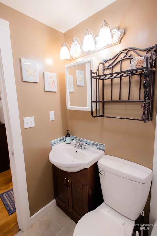 260 State St, Grand View, ID 83624 - half bath featuring toilet, vanity, baseboards, and tile patterned floors