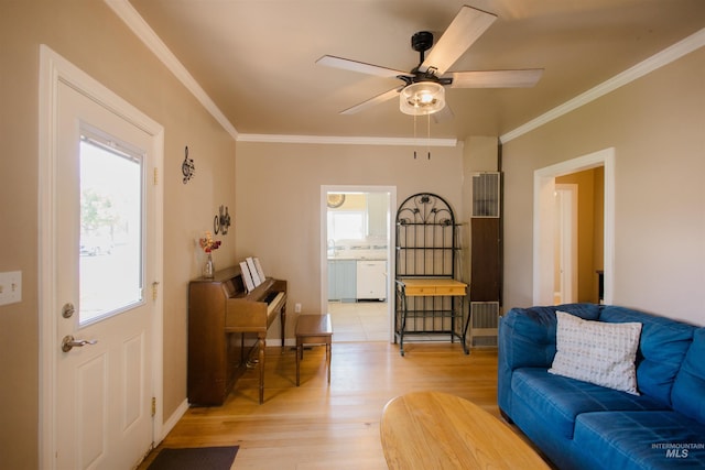 260 State St, Grand View, ID 83624 - living area featuring a heating unit, light wood finished floors, crown molding, ceiling fan, and baseboards