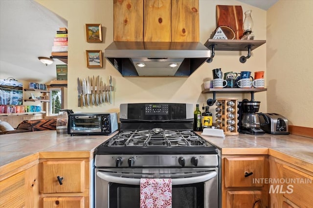150 W Yuba Vista Dr, Atlanta, ID 83716 - kitchen with stainless steel gas stove, under cabinet range hood, open shelves, open floor plan, and brown cabinets