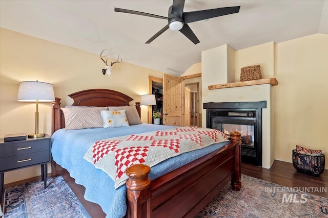 150 W Yuba Vista Dr, Atlanta, ID 83716 - bedroom featuring vaulted ceiling, wood finished floors, a multi sided fireplace, and a ceiling fan