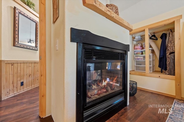 150 W Yuba Vista Dr, Atlanta, ID 83716 - detailed view of a multi sided fireplace, wood finished floors, wainscoting, and wooden walls