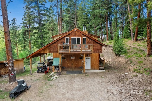 150 W Yuba Vista Dr, Atlanta, ID 83716 - view of front of house featuring a chimney, board and batten siding, and a deck