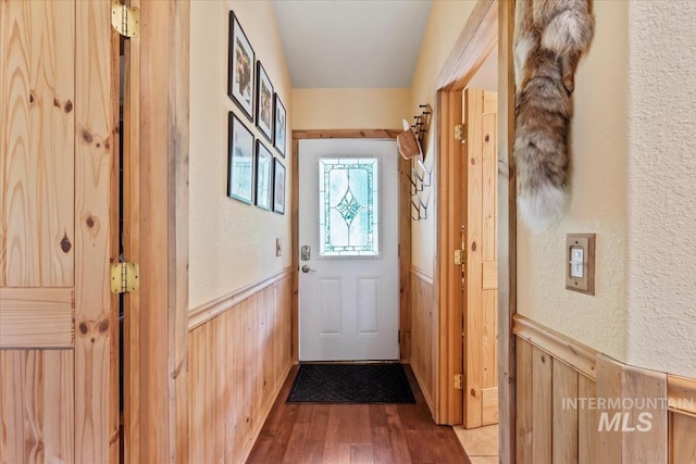 150 W Yuba Vista Dr, Atlanta, ID 83716 - doorway with a wainscoted wall, wood walls, wood finished floors, and a textured wall