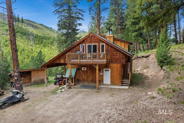 150 W Yuba Vista Dr, Atlanta, ID 83716 - view of front of property with dirt driveway, a deck, and stairs