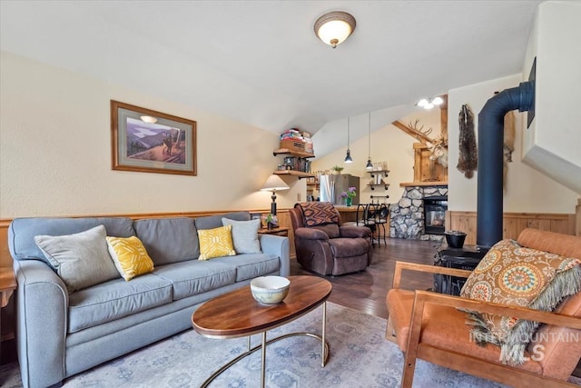 150 W Yuba Vista Dr, Atlanta, ID 83716 - living area with wood finished floors, a wainscoted wall, lofted ceiling, and a stone fireplace