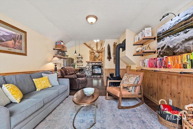 150 W Yuba Vista Dr, Atlanta, ID 83716 - living area with wood finished floors, a wainscoted wall, lofted ceiling, a wood stove, and wood walls