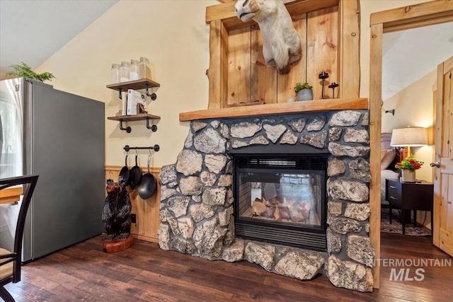 150 W Yuba Vista Dr, Atlanta, ID 83716 - detailed view of freestanding refrigerator, wood finished floors, a fireplace, and wainscoting