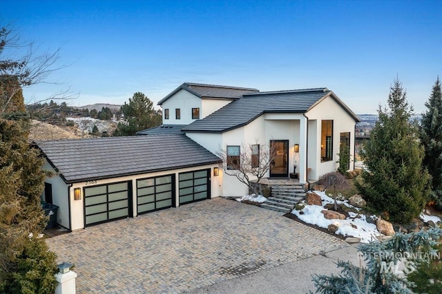 modern inspired farmhouse featuring a mountain view and a garage