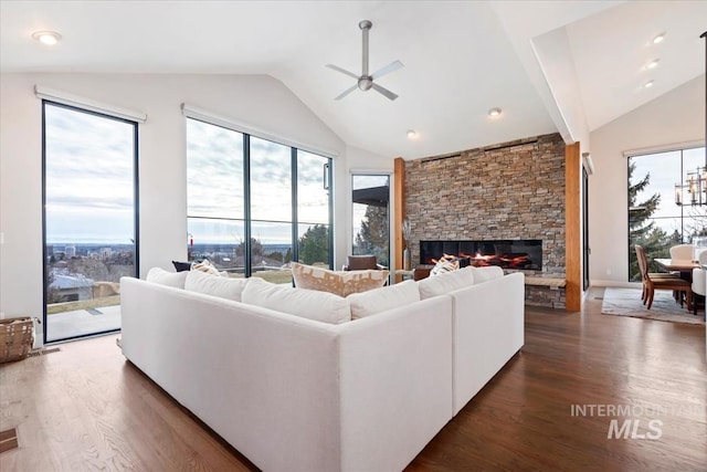 living room featuring a fireplace, ceiling fan, high vaulted ceiling, and dark hardwood / wood-style floors