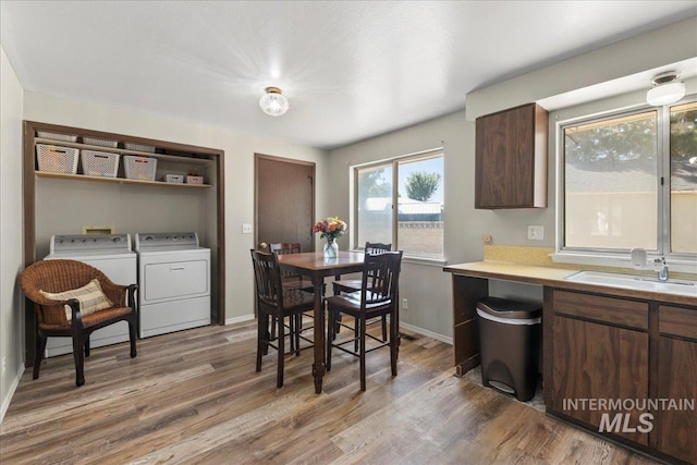 131 Goodall Pl, Mountain Home, ID 83647 - kitchen with a sink, washing machine and clothes dryer, wood finished floors, and light countertops
