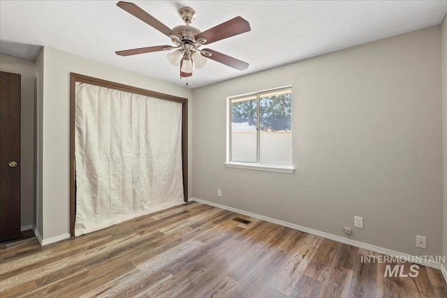 131 Goodall Pl, Mountain Home, ID 83647 - unfurnished bedroom with wood finished floors, baseboards, and ceiling fan