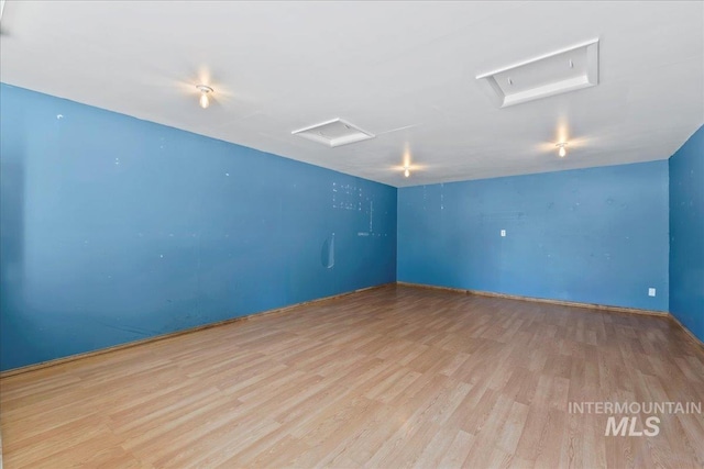 131 Goodall Pl, Mountain Home, ID 83647 - unfurnished room featuring attic access, wood finished floors, and baseboards
