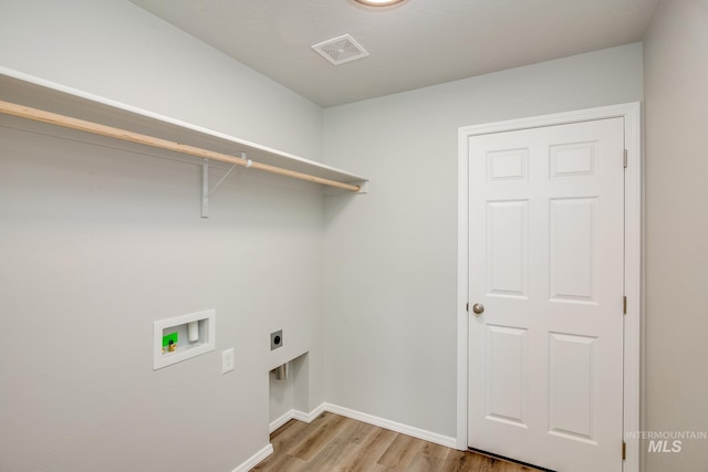 clothes washing area with light hardwood / wood-style flooring, hookup for a washing machine, and electric dryer hookup