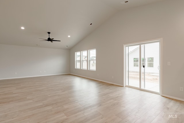 spare room with ceiling fan, high vaulted ceiling, and light hardwood / wood-style flooring